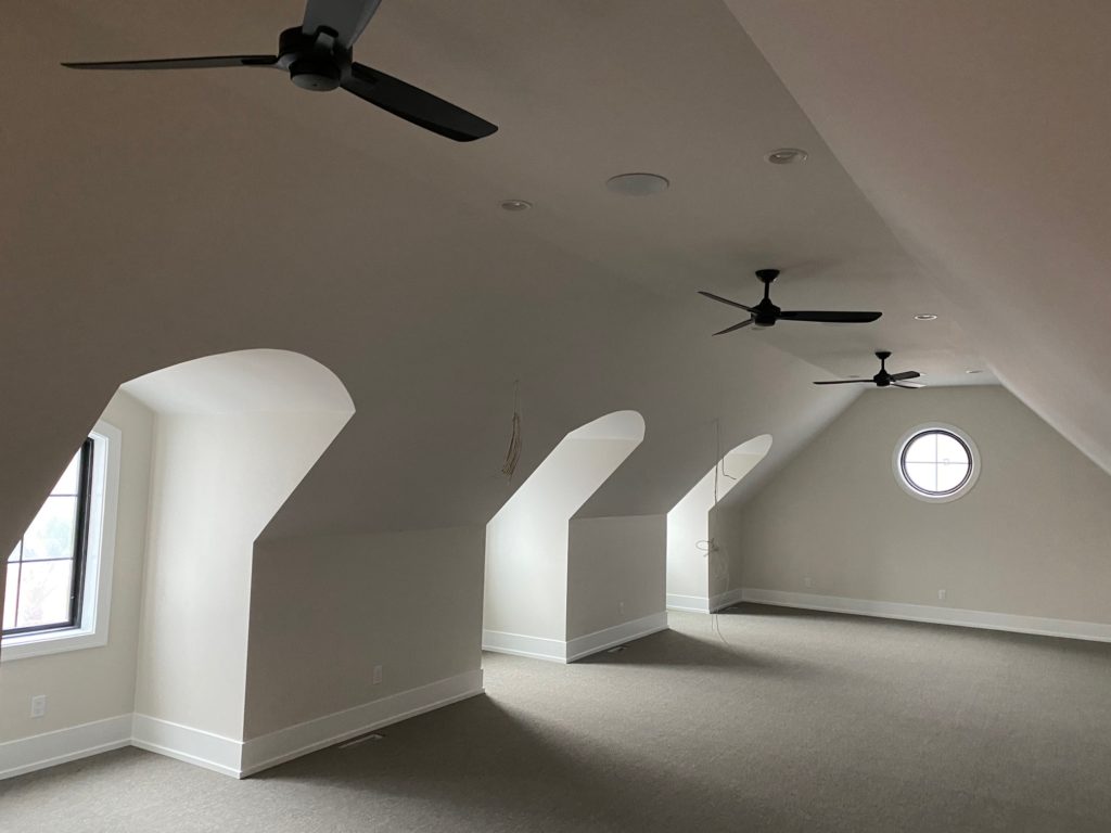 Bonus room with dormers Bonus room with dormer windows and vaulted ceilings in a custom home floor plan